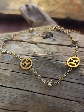 Gold-Tone Logo Disc Link Bracelet with Crystal Accents